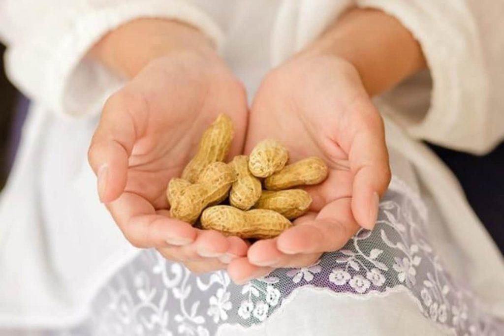 رژیم کبد چرب فردی که در دستش بادام دارد